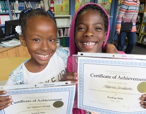 Two Succeeding by Reading students celebrate success.