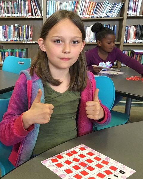 Julianna gives a thumbs up to learning math.