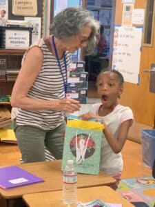 Da’myla receives the gift of a new book.